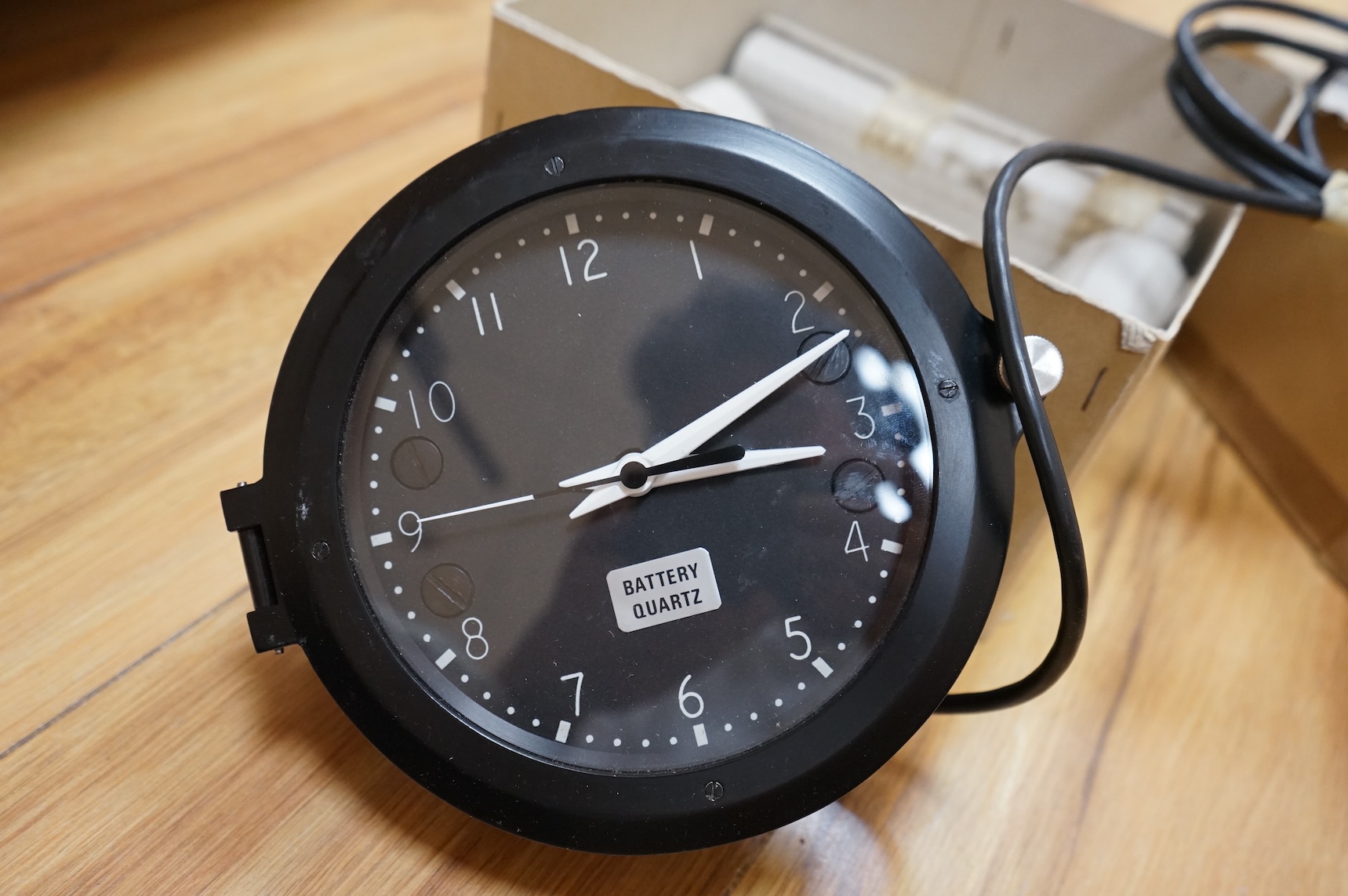 A modern British MOD Royal Navy issue quartz powered electric timepiece by S.I.R.S. Navigation Ltd. in its original card issue box